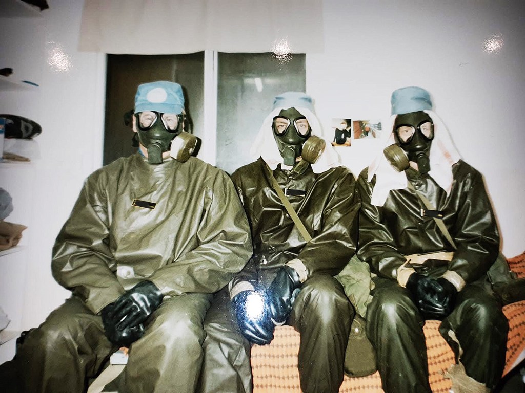 Tre personer i skyddskläder och skyddsmask under ett gaslarm.